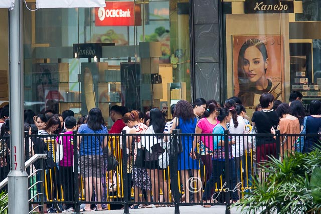 Crowd forming in front of the shopping centre at Orchard Road 